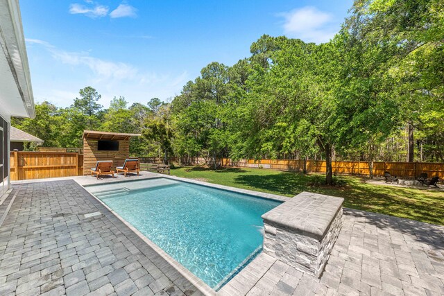 view of swimming pool with a patio, a fenced in pool, a fenced backyard, and a yard