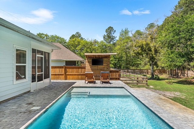 view of swimming pool with a lawn, a fenced in pool, a fenced backyard, and a patio area