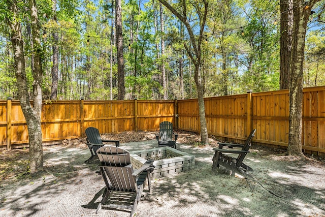 view of yard with a fire pit and a fenced backyard