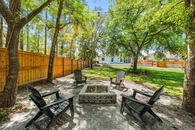 view of patio / terrace with an outdoor fire pit and fence