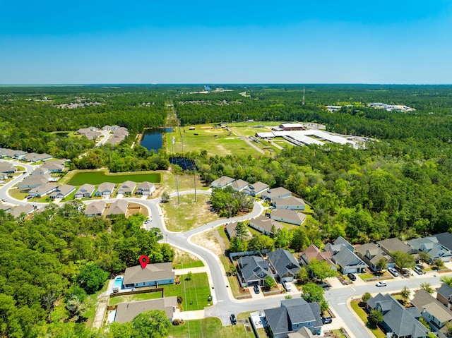 bird's eye view with a water view, a view of trees, and a residential view