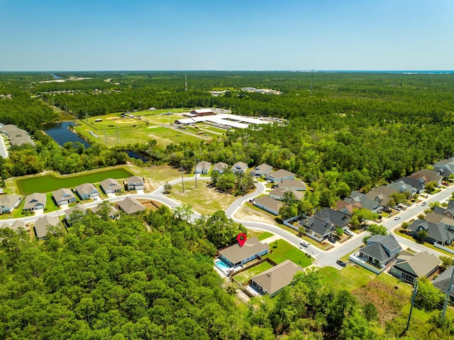 birds eye view of property featuring a water view, a residential view, and a view of trees