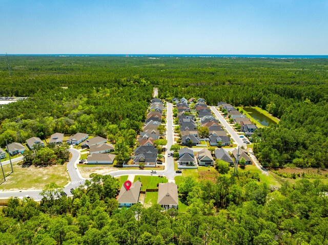 drone / aerial view with a residential view and a forest view