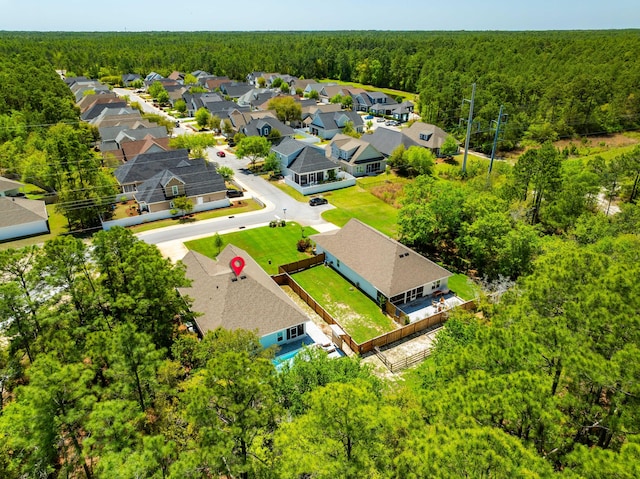 aerial view featuring a residential view and a wooded view
