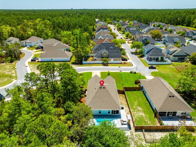 birds eye view of property featuring a residential view and a forest view