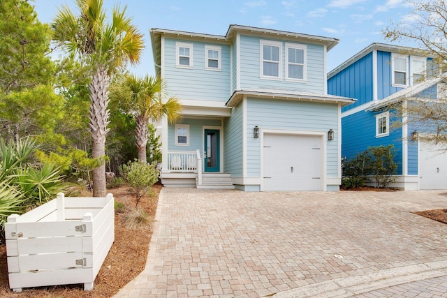 374 Gulfview Cir, Santa Rosa Beach, FL 32459 - view of front of property with decorative driveway, metal roof, a garage, and covered porch
