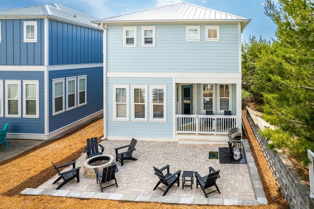 374 Gulfview Cir, Santa Rosa Beach, FL 32459 - rear view of house featuring an outdoor fire pit, a standing seam roof, metal roof, and a patio area