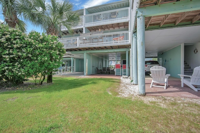 8522 Gulf Blvd Unit 20, Navarre, FL 32566 - rear view of house with a lawn, stairs, and a patio area