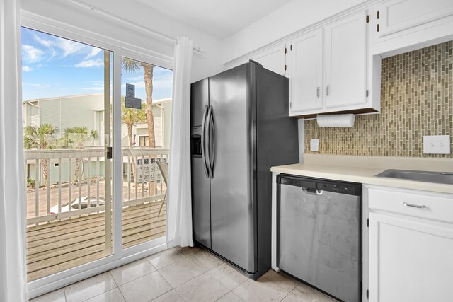 8522 Gulf Blvd Unit 20, Navarre, FL 32566 - kitchen with tasteful backsplash, light tile patterned floors, stainless steel appliances, light countertops, and white cabinetry