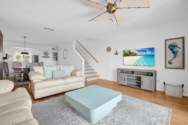 8522 Gulf Blvd Unit 20, Navarre, FL 32566 - living area with stairway, wood finished floors, visible vents, baseboards, and ceiling fan