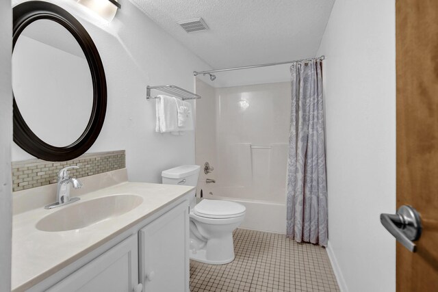 8522 Gulf Blvd Unit 20, Navarre, FL 32566 - bathroom with a textured ceiling, toilet, visible vents, decorative backsplash, and vanity
