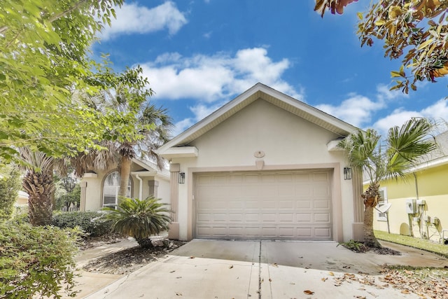 226 Talquin Cv, Destin, FL 32541 - view of front of house with an attached garage, stucco siding, and concrete driveway