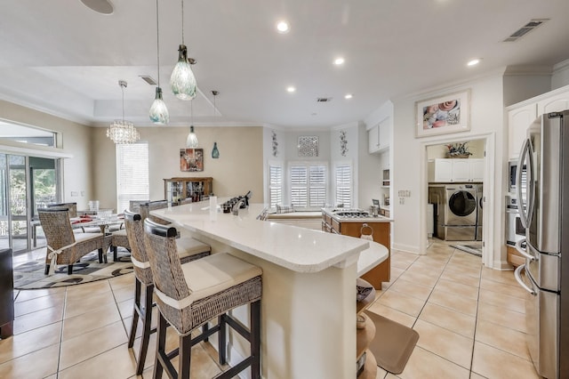 226 Talquin Cv, Destin, FL 32541 - kitchen with visible vents, a large island, light tile patterned flooring, and stainless steel appliances