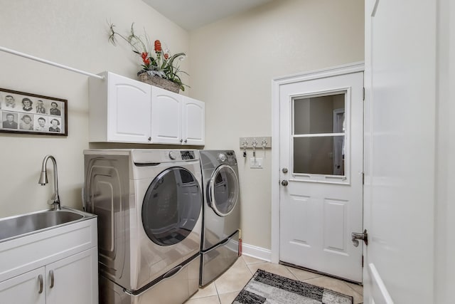 226 Talquin Cv, Destin, FL 32541 - washroom with cabinet space, a sink, baseboards, light tile patterned flooring, and washer and dryer