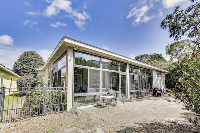226 Talquin Cv, Destin, FL 32541 - rear view of house with a sunroom, fence, and a patio