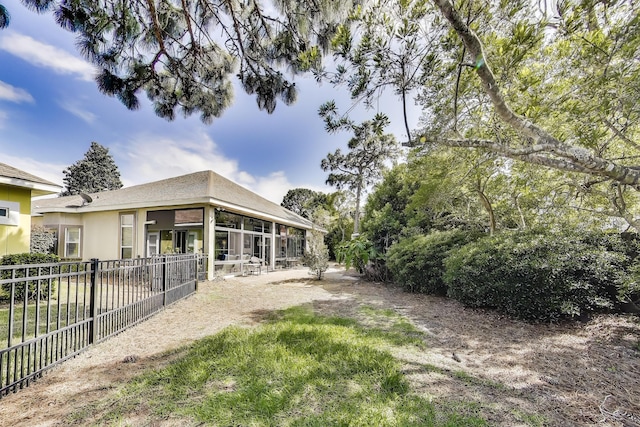 226 Talquin Cv, Destin, FL 32541 - rear view of house with fence, a sunroom, and stucco siding