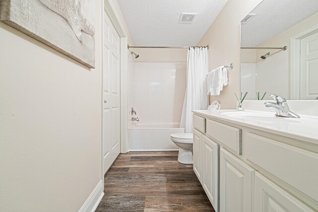 112 Seascape Dr Unit 707, Miramar Beach, FL 32550 - bathroom with wood finished floors, toilet, vanity, visible vents, and shower / tub combo with curtain