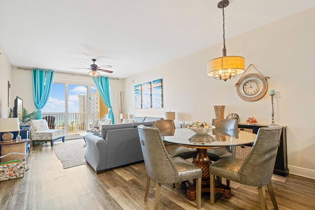 112 Seascape Dr Unit 707, Miramar Beach, FL 32550 - dining area with wood finished floors, a ceiling fan, and baseboards