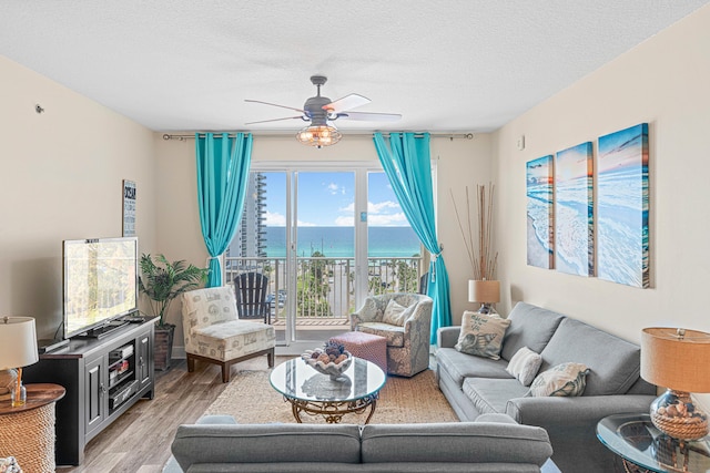 112 Seascape Dr Unit 707, Miramar Beach, FL 32550 - living room featuring a textured ceiling, light wood-style floors, and a ceiling fan
