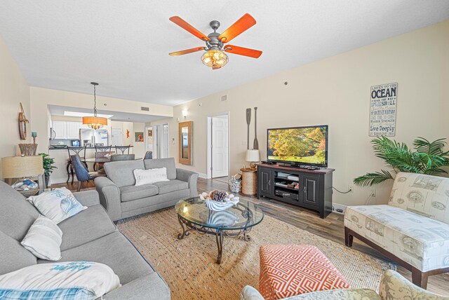 112 Seascape Dr Unit 707, Miramar Beach, FL 32550 - living room with wood finished floors, ceiling fan, visible vents, and baseboards