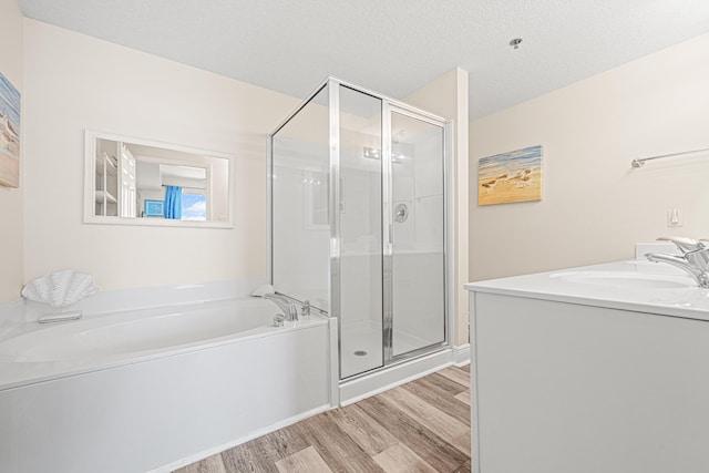 112 Seascape Dr Unit 707, Miramar Beach, FL 32550 - bathroom featuring a bath, a sink, a shower stall, and wood finished floors