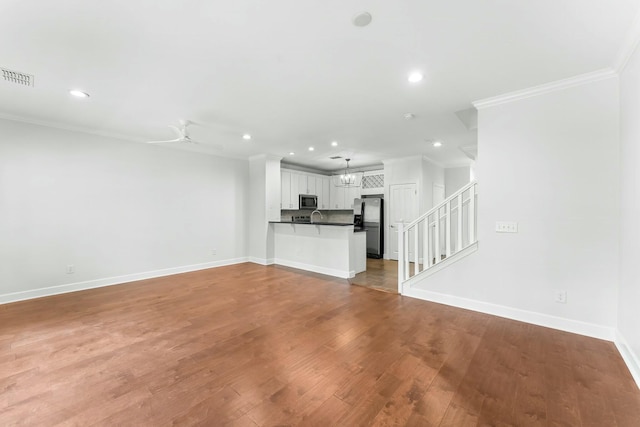 unfurnished living room featuring recessed lighting, stairway, ornamental molding, baseboards, and visible vents
