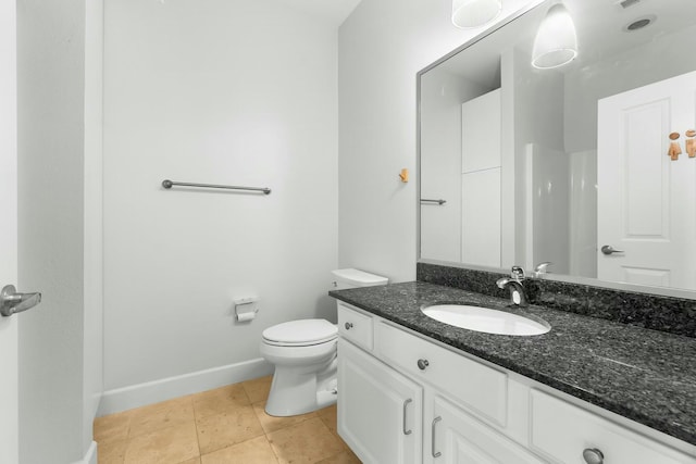 bathroom featuring tile patterned floors, toilet, vanity, and baseboards
