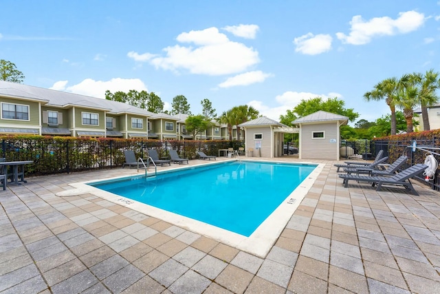 pool featuring a patio and fence