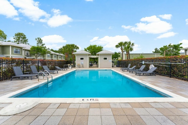 community pool featuring a patio and fence