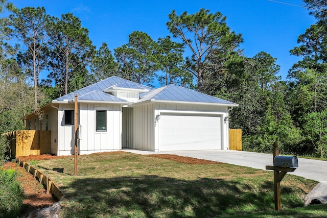 ranch-style house featuring board and batten siding, a front yard, a garage, fence, and concrete driveway
