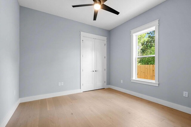 42 Central 8th St, Santa Rosa Beach, FL 32459 - unfurnished bedroom featuring baseboards, ceiling fan, wood-type flooring, and a closet