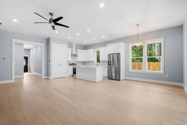 42 Central 8th St, Santa Rosa Beach, FL 32459 - unfurnished living room featuring a ceiling fan, baseboards, and plenty of natural light