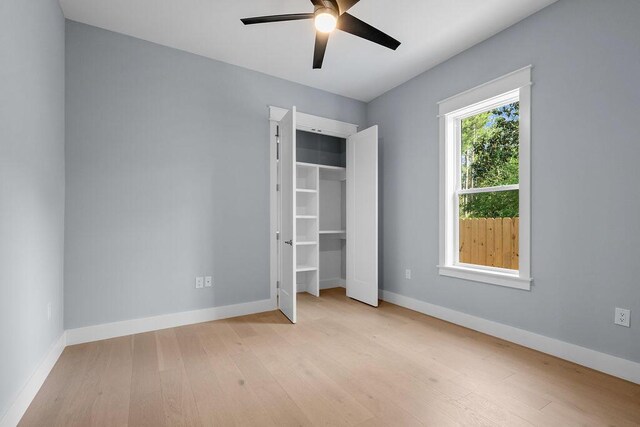 42 Central 8th St, Santa Rosa Beach, FL 32459 - unfurnished bedroom featuring baseboards, ceiling fan, wood finished floors, and a closet