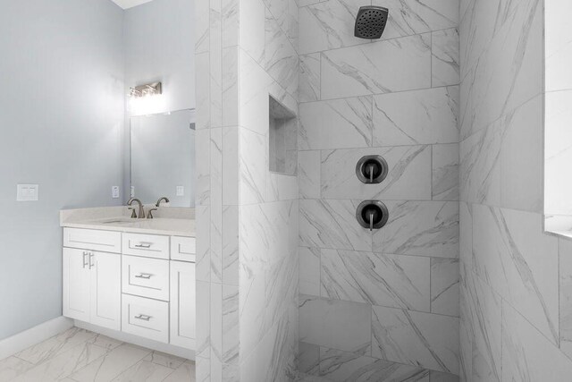 42 Central 8th St, Santa Rosa Beach, FL 32459 - bathroom with baseboards, tiled shower, marble finish floor, and vanity