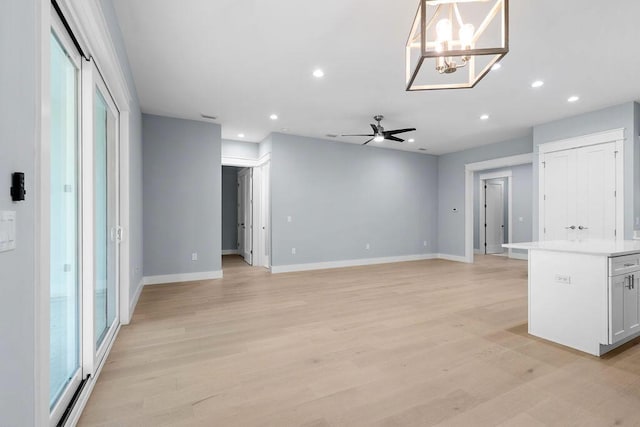 42 Central 8th St, Santa Rosa Beach, FL 32459 - unfurnished living room featuring recessed lighting, baseboards, and ceiling fan with notable chandelier