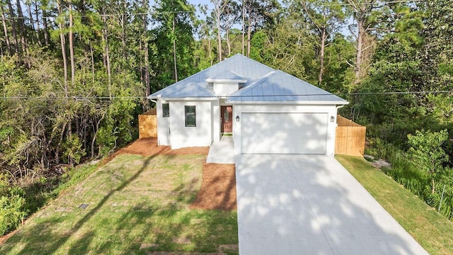 42 Central 8th St, Santa Rosa Beach, FL 32459 - view of front of house with a standing seam roof, metal roof, a front yard, a garage, and concrete driveway