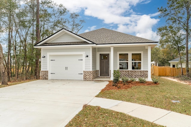 view of front facade with a garage, brick siding, a shingled roof, and driveway