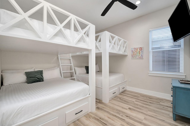 bedroom with light wood-type flooring, baseboards, and ceiling fan