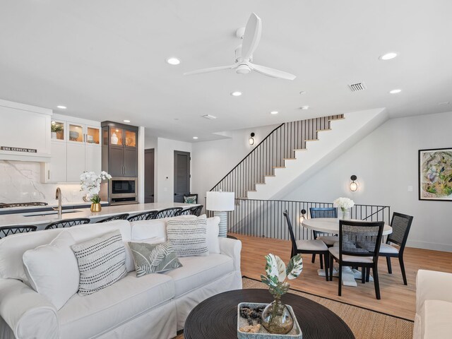 101 Deluna Pl Unit C, Panama City Beach, FL 32413 - living room with light wood finished floors, a ceiling fan, baseboards, and recessed lighting