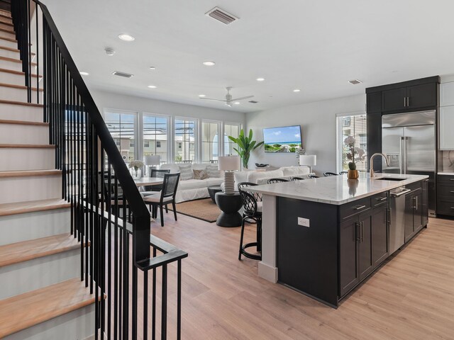 101 Deluna Pl Unit C, Panama City Beach, FL 32413 - kitchen with a sink, light wood-style floors, stainless steel appliances, visible vents, and recessed lighting