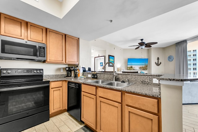 4207 Indian Bayou Trl Unit 2501, Destin, FL 32541 - kitchen featuring a sink, dark stone counters, a peninsula, a ceiling fan, and black appliances