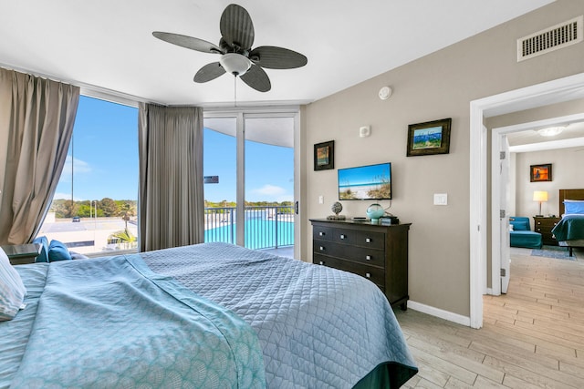 4207 Indian Bayou Trl Unit 2501, Destin, FL 32541 - bedroom with visible vents, access to exterior, multiple windows, and light wood-type flooring