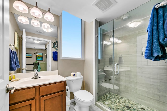 4207 Indian Bayou Trl Unit 2501, Destin, FL 32541 - full bathroom with visible vents, a shower stall, toilet, and vanity