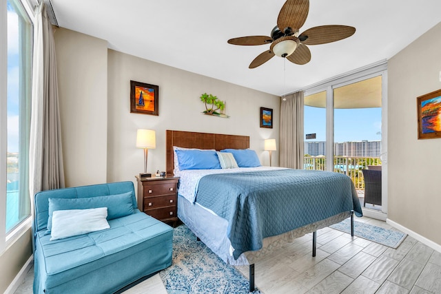 4207 Indian Bayou Trl Unit 2501, Destin, FL 32541 - bedroom featuring baseboards, a ceiling fan, multiple windows, and access to exterior