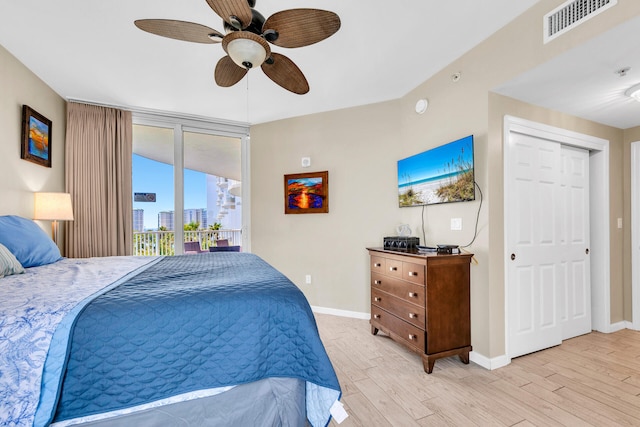 4207 Indian Bayou Trl Unit 2501, Destin, FL 32541 - bedroom featuring visible vents, access to exterior, light wood-style floors, baseboards, and ceiling fan