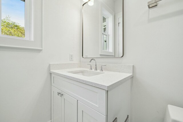 bathroom featuring toilet and vanity