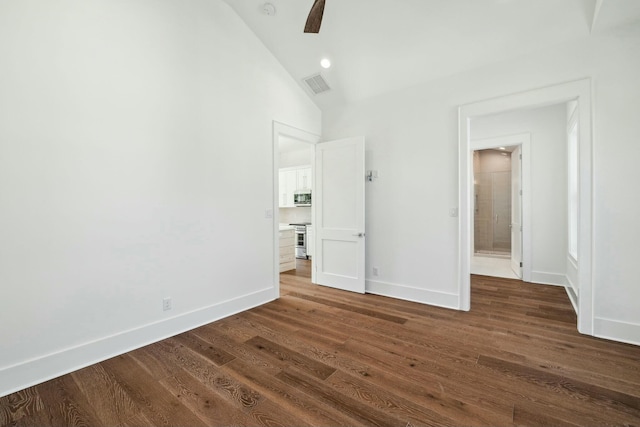 unfurnished bedroom featuring dark wood-style flooring, a ceiling fan, visible vents, baseboards, and lofted ceiling