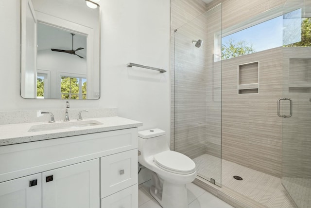 full bath featuring toilet, vanity, a shower stall, and tile patterned floors
