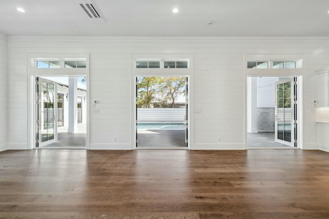 interior space featuring wood finished floors, recessed lighting, visible vents, and baseboards