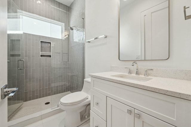 full bath with vanity, toilet, tile patterned flooring, and a stall shower